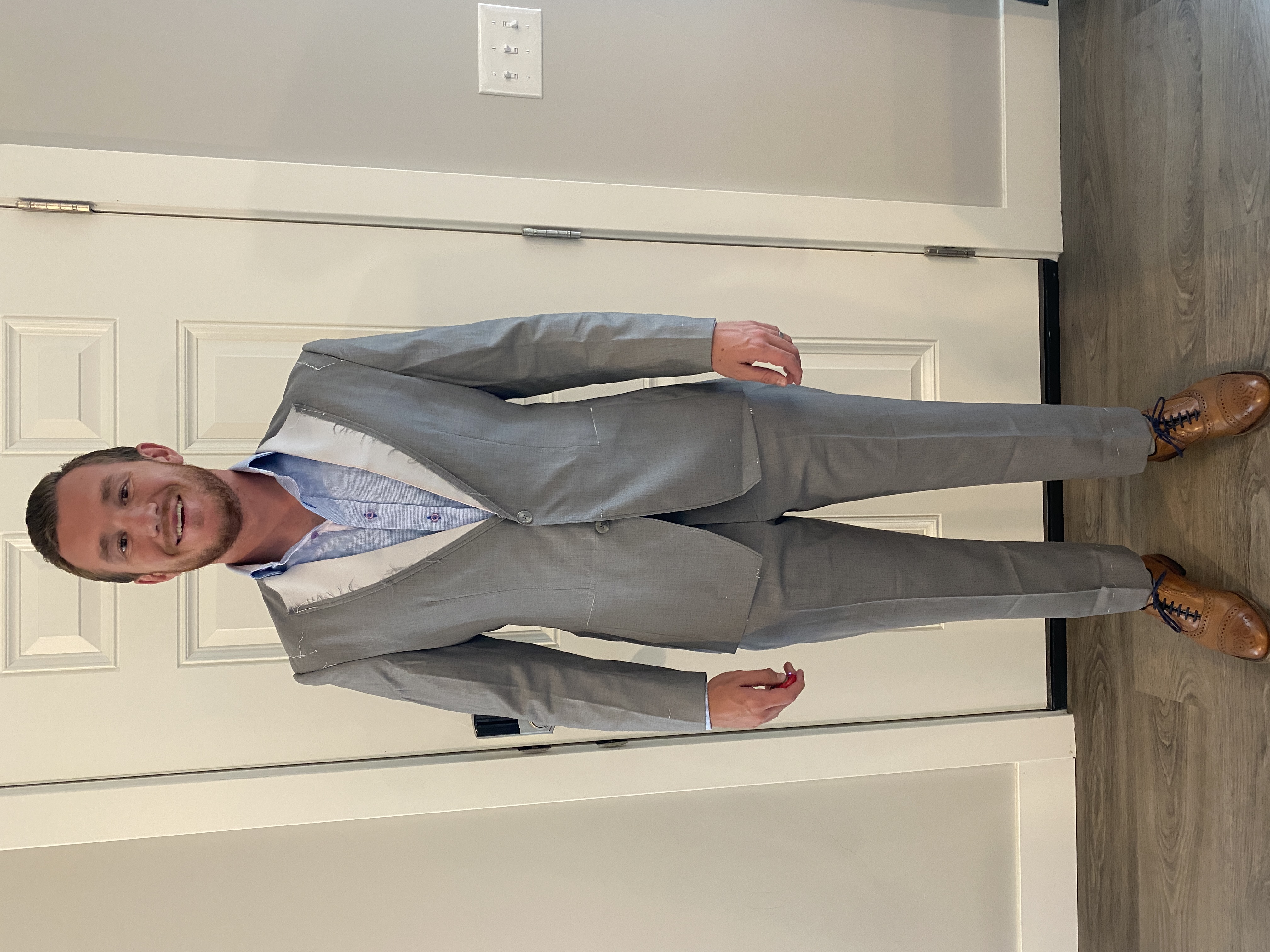 Expert bespoke fitting process demonstration at Essato Custom Clothing, showcasing our unique fitting suit method for achieving perfect measurements in Layton, Utah