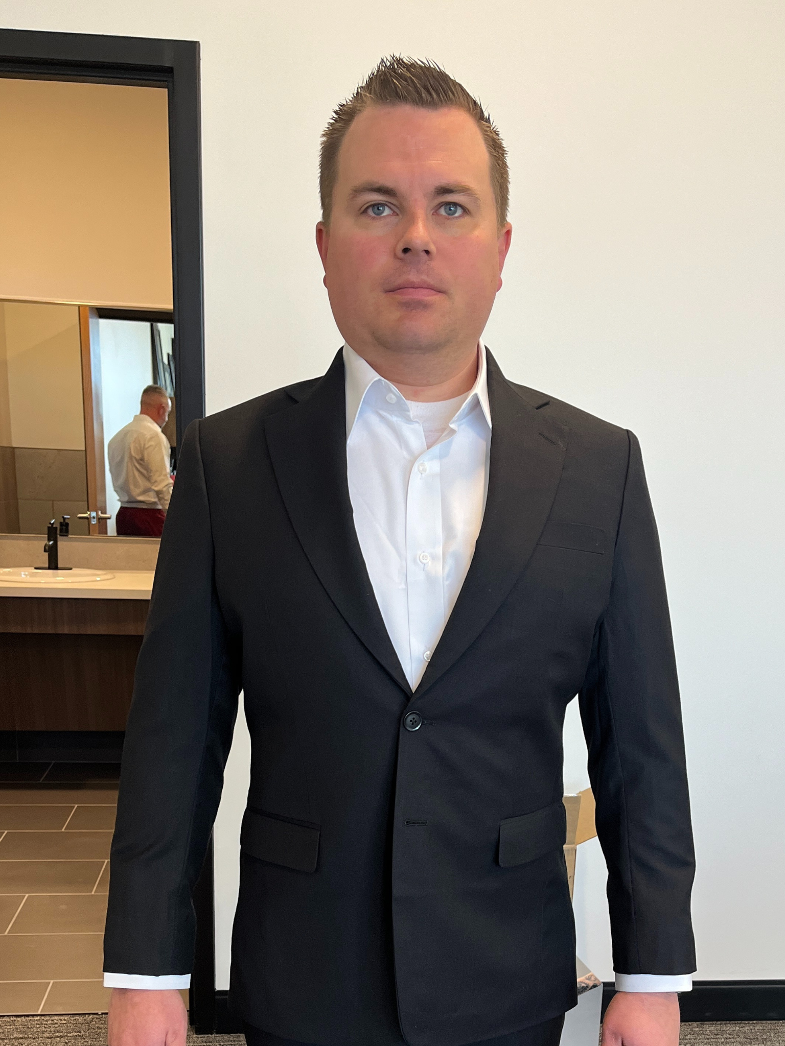 Bespoke suit fitting and adjustment process at Essato Custom Clothing in Layton, Utah