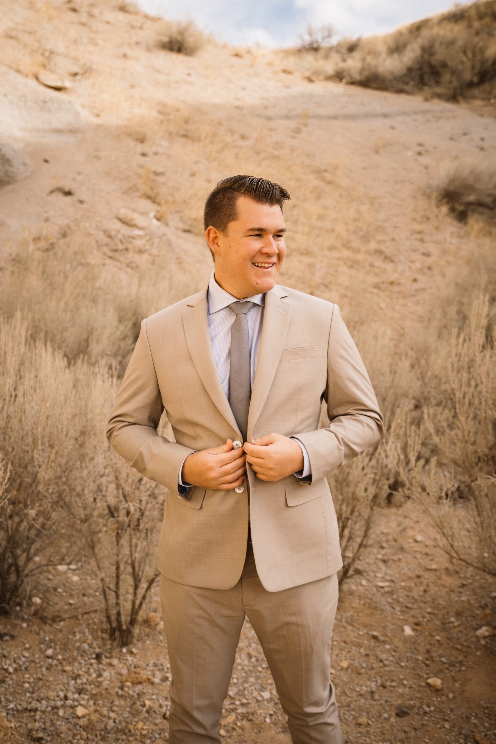 Elegant custom-tailored tan wedding suit perfectly styled for a desert setting, showcasing Essato Custom Clothing's versatile designs in Layton, Utah